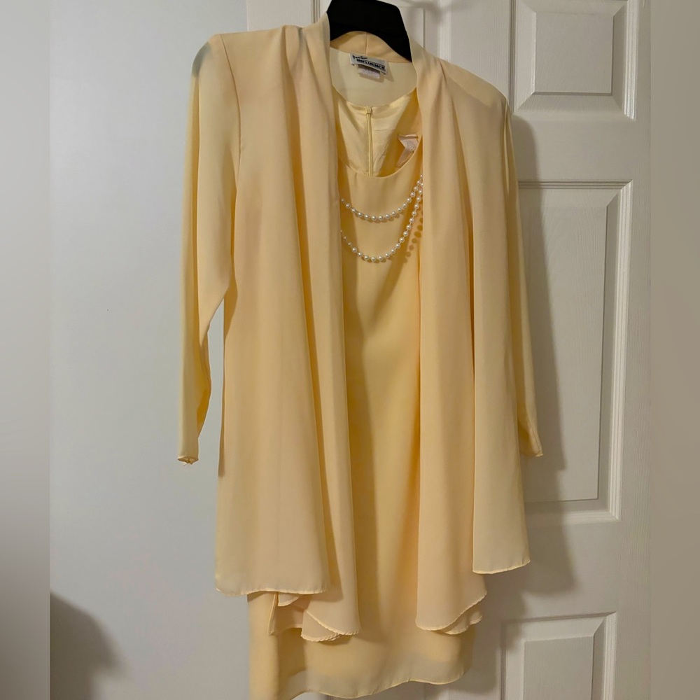 Dress with matching jacket and coordinating pearl necklace.